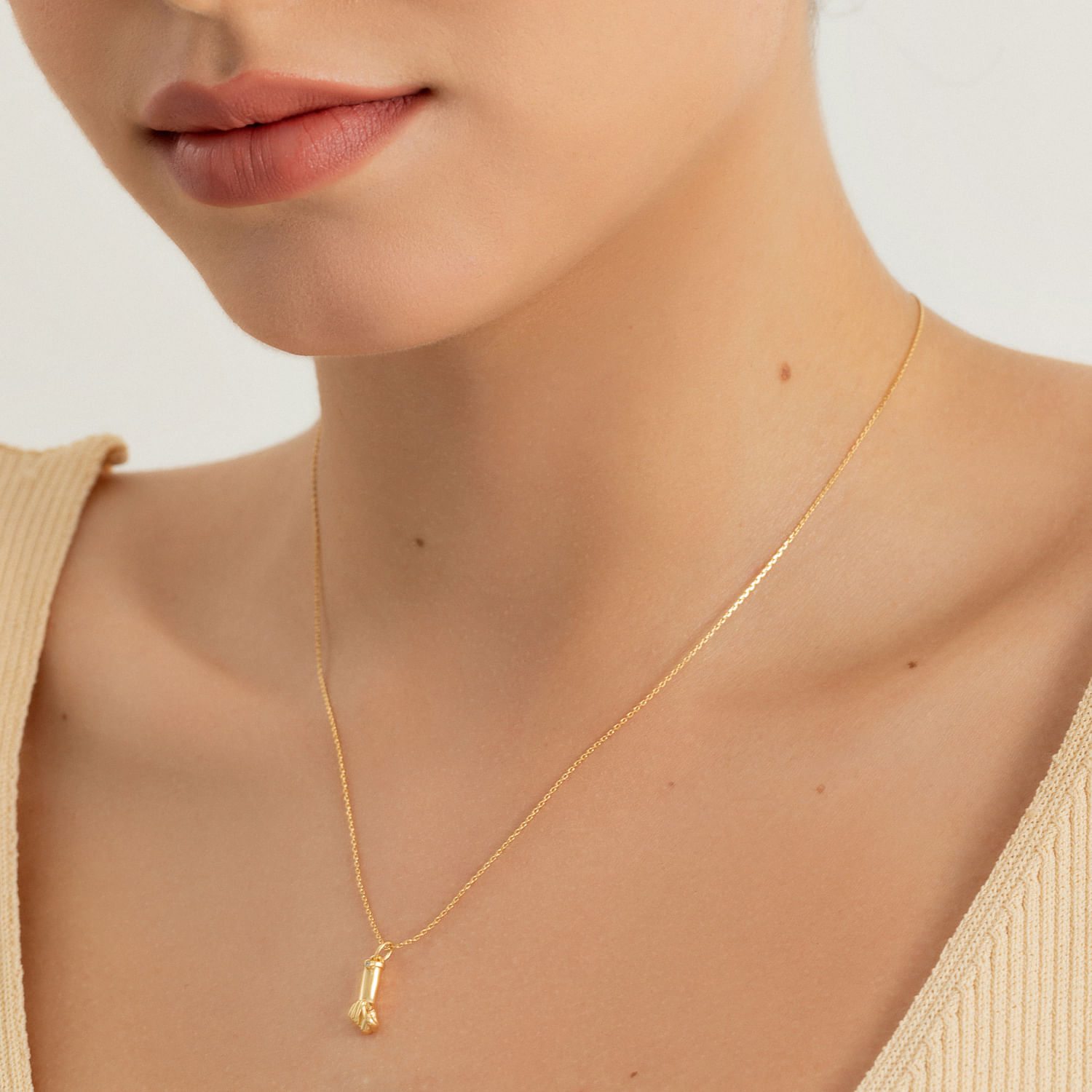 Colar dourado delicado com pingente em forma de letra "H".